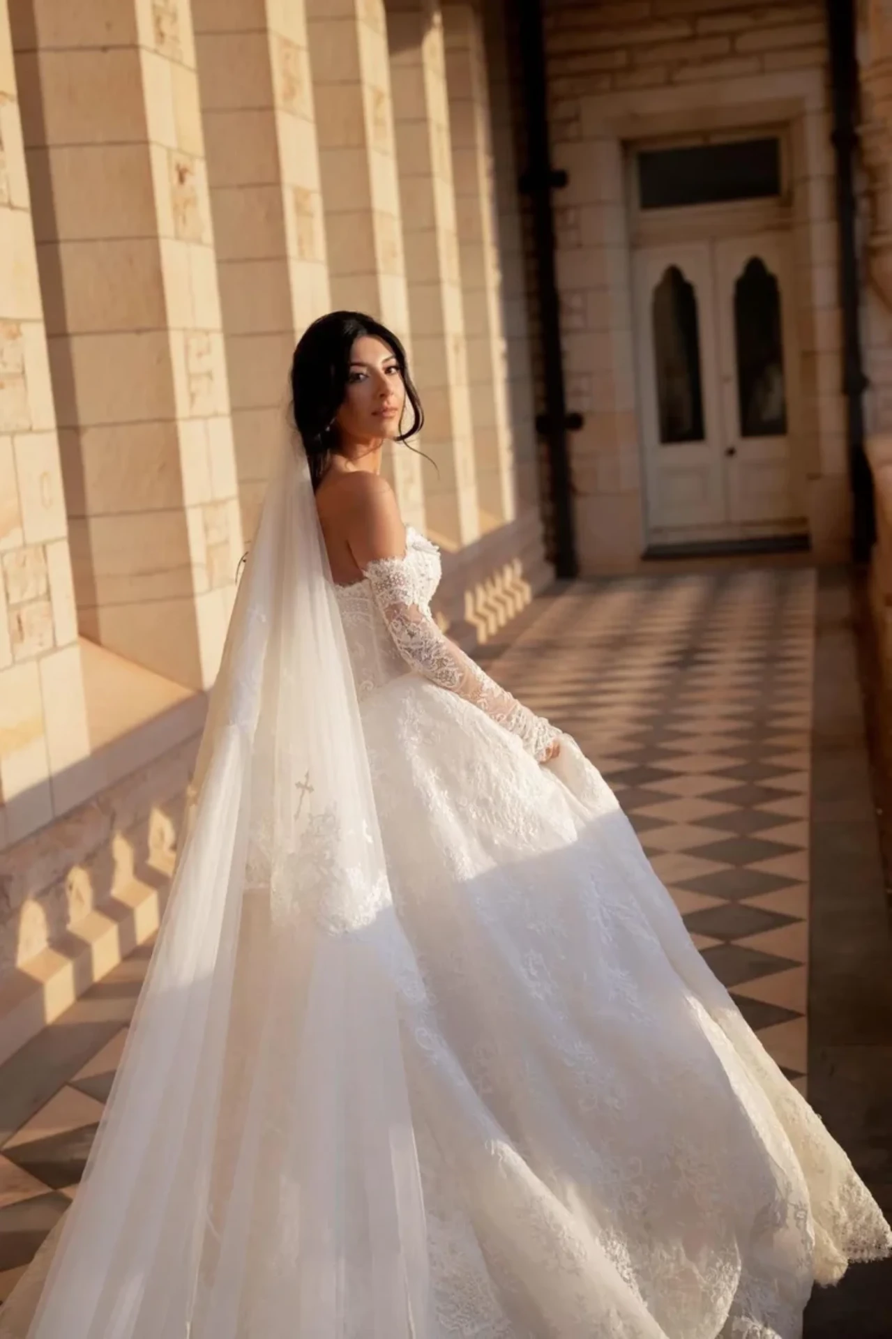 Bride in a lace gown with glowing skin prepared through a bridal skin journey